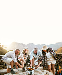 Image showing Melting marshmallows by a fire on a nature getaway vacation, senior group bonding and relaxing together with candy in the mountain. People on fun hiking holiday, adventure or freedom with copy space