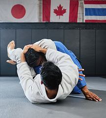 Image showing . Male martial arts, fighting at a dojo and holding his opponent. Karate, sports and taekwondo adults training at the gym for a fight. Athlete, aikido and practicing for an international competition.