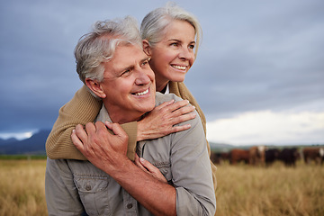 Image showing Mature couple embracing and looking happy while bonding outdoors at a farm, carefree and loving. Senior husband and wife having peaceful day in nature, enjoying retirement and relationship