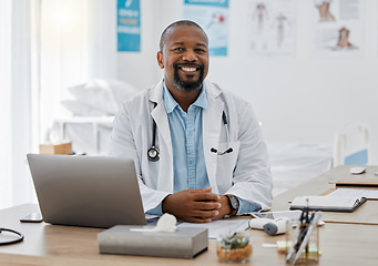 Image showing Doctor, medical healthcare worker and male physician at hospital or clinic working with stethoscope and electronics. GP man on laptop reading emails, patient records and documents in covid pandemic