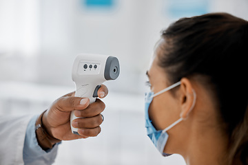Image showing Compliance, healthcare and covid with a doctor scanning a patient temperature with infrared thermometer, checking for a fever. Concerned woman suffering from corona, flu or cold in exam or consult