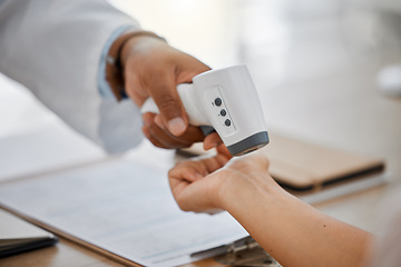 Image showing Medical doctor measure with infrared digital thermometer in a clinic consulting appointment for covid. Healthcare worker check for coronavirus for health and safety in hospital office