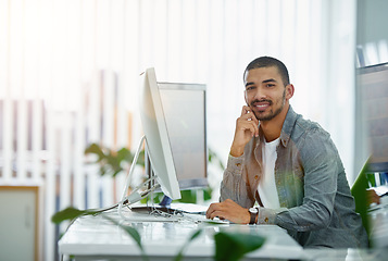 Image showing Portrait of a happy business man typing on a computer, proud while working in a modern office. Confident , checking budget and savings while looking at online data