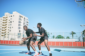 Image showing Basketball, sports and game between sporty male players having fun while playing on a court outdoors. Young black friends training and being active together while competing in a competitive sport