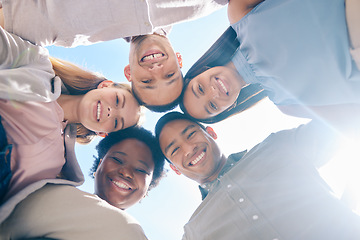 Image showing Diverse group of friends in a huddle together showing unity, trust and support outdoors in summer from below. International, happy and young men and women smiling, united and cheerful team outside