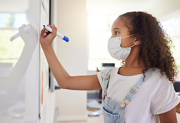 Image showing Smart, clever and intelligent girl writing an answer on a whiteboard at elementary school during the covid pandemic. Child development or quality education for a young kid learning in class