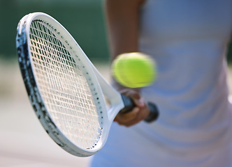 Image showing Closeup tennis ball, racket and sport for fit, active and healthy player hitting, training and exercising for practice. Professional player warming up for routine workout and exercise match on court
