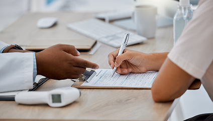 Image showing Patient hands writing, filling in medical insurance form for information in professional clinic or hospital room. Doctor, medicine consultant or healthcare worker advising woman during consultation.