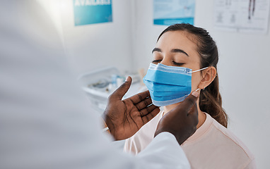 Image showing Female patient in thyroid exam from doctor, checking throat for covid virus in gp appointment or medical checkup in hospital. Woman with health insurance and face mask getting healthcare treatment