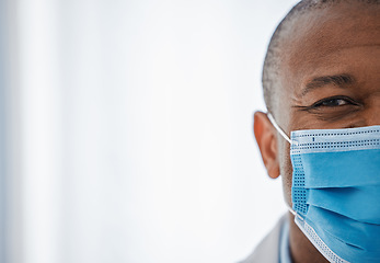 Image showing Covid medical face mask by a healthcare professional with copy space to prevent the spread of covid19. The happy, smiling and half face of a male with protection from the coronavirus