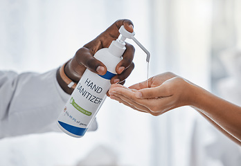 Image showing Doctor apply hand sanitizer cleaning, hygiene and covid procedures during quarantine. Medical, healthcare and safety professional disinfecting their hands to protect from corona virus or covid19