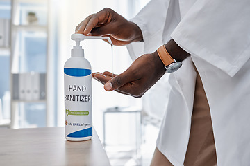 Image showing Covid, hand sanitizer and hygiene by doctor, healthcare worker and medical professional in clinic, hospital and wellness center. Closeup of consulting man cleaning virus, bacteria and germs off hands