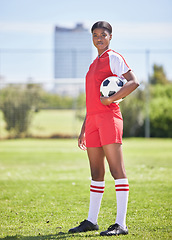 Image showing Strong and confident soccer football female player with ball for practice and training on sports field. Portrait of determined and competitive woman in sport kit ready for game or match to start