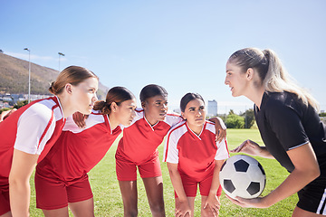 Image showing Sports, soccer players and football coach giving women motivation to score goals in the stadium. Collaboration, fitness and healthy girls in a huddle ready to use teamwork on a grass field in summer