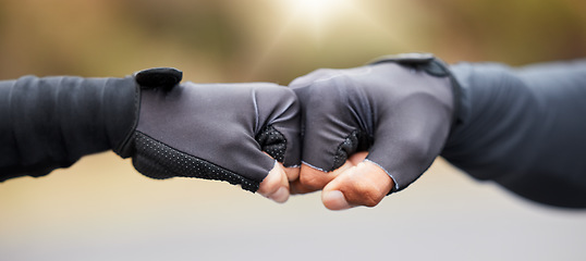 Image showing Motivation, teamwork and unity with hands in gloves fist bump to show collaboration, solidarity and working together. Closeup of people showing success, community and achieving a goal as a team