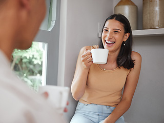 Image showing Happy, carefree and laughing woman drinking coffee in the morning and having fun with her boyfriend at home. Young and excited female laughs at a funny joke while and enjoying time with her partner