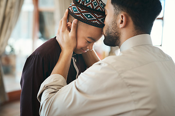 Image showing Muslim father, parent or man kissing his son on the forehead, bonding and showing affection at home. Happy, smiling and Arab boy embracing, celebrating traditional holiday and being peaceful with dad