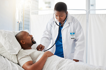 Image showing Medical doctor doing heart health checkup on patient in bed, listening for healthy heartbeat and consulting black man after surgery at hospital. Sick male person doing tests with healthcare worker