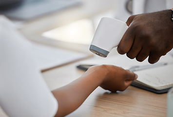 Image showing Doctor checking wrist temperature of sick covid patient to test for fever, risk of disease or flu. Closeup on hands scanning with laser thermometer for healthcare and virus safety in medical hospital