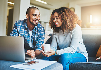 Image showing Home finance, savings and investment with a young couple working on a laptop in their living room. Man and woman calculating a household budget together while relaxing and drinking coffee on the sofa