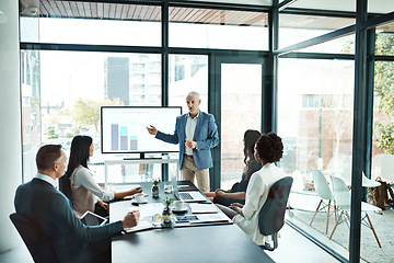 Image showing Businesspeople attending a presentation in the boardroom about growth, innovation and development with graphs in a boardroom. Mature man showing great leadership while talking about company vision