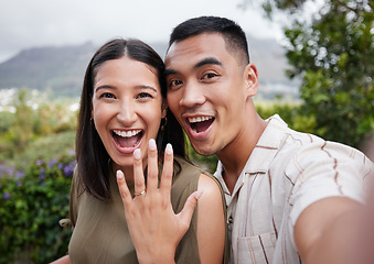 Image showing Engagement, ring and celebration with a young couple announcing their happy news and special occasion. Closeup portrait of a man and woman taking a selfie after getting engaged to be married outside