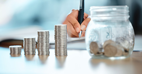 Image showing Hands of a bank teller, accountant or finance worker counting coins, money and writing down the numbers for a audit. Closeup of a financial advisor analyzing a clients expenses, savings or capital