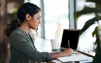 Image showing Writing, serious and freelance young woman working with laptop and notebook at a cafe. Creative remote worker or female student planning, brainstorming a mind map about future career.