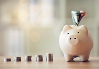 Image showing . Banking, accounting and financial management to plan for the future, collect a rainy day fund and profit. Piggybank, saving and finance with money, coins and cash in a coin bank on a table at home.