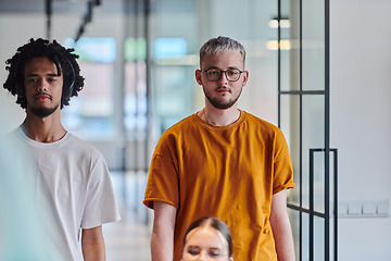 Image showing A modern portrait captures a blue-haired businessman wearing glasses, exuding creativity and professionalism, within the ambiance of a startup coworking office