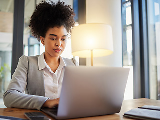 Image showing Laptop, typing and serious business woman reading emails at desk. Formal, professional and worker with focus and commitment to her job. Office employee working on computer in a corporate workplace.