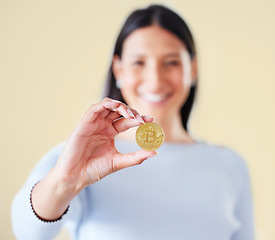 Image showing Bitcoin, money and coin of a woman trader or broker holding a real cryptocurrency or virtual token. Female investor happy about her investment, trading and getting value for financial growth.