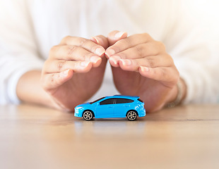 Image showing Care insurance, security and safety with the hands of a broker covering model or toy transport on a table in a corporate office. Finance, accountant and travel with an employee offering vehicle cover