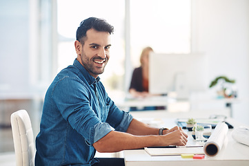 Image showing Happy creative businessman working at his desk, doing admin and taking notes while in an office at work. Portrait of a cheerful, smiling and professional male with a positive attitude and expression