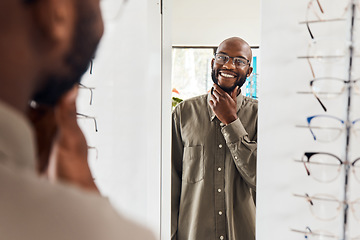 Image showing Customer trying on glasses at an optometrist, smiling and looking confident with choice at optical store . Carefree man buying trendy spectacles to help with vision. Excited male satisfied with frame