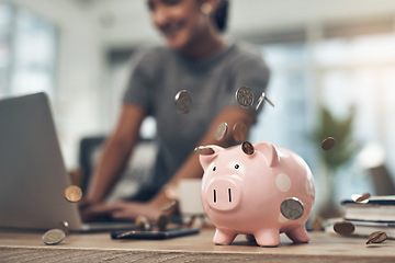 Image showing Financial strategy, investment or finance saving with a piggybank and coins falling out on a desk. Bank cash and money or digital budget growth of a person looking at online banking in the background