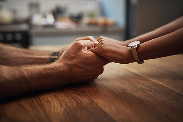 Image showing Couple holding hands in support, grief and healing together on a wooden table at home. Closeup of a caring partner in sorrow due to cancer and expressing feelings of compassion in a house