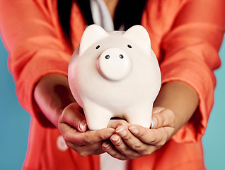 Image showing Closeup of hands holding a piggy bank with her savings and financial investments. Stylish, trendy and elegant female with future planning, looking after her wealth growth developments.