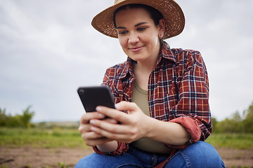 Image showing Farmer texting or scrolling on social media on a phone for online sustainability tips relaxing on an organic farm. Nature activist browsing and searching the internet for sustainable farming ideas