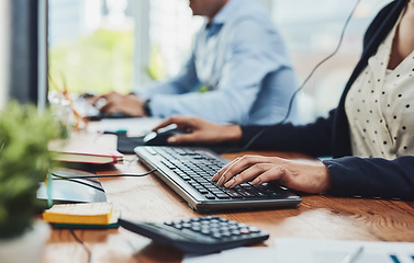 Image showing Hands of woman typing on keyboard in a call center for client data. Closeup of busy woman in customer service giving clients online support through communication with colleague in the background.