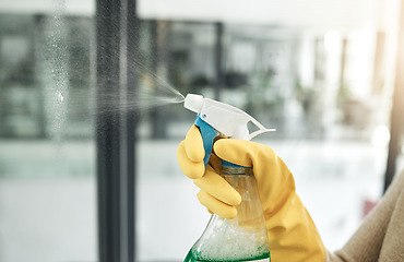 Image showing Clean, wash and day chores at home with a household hygiene spray bottle for windows inside. Closeup of cleaning job, washing and working hand with gloves spraying glass cleaner with care indoors