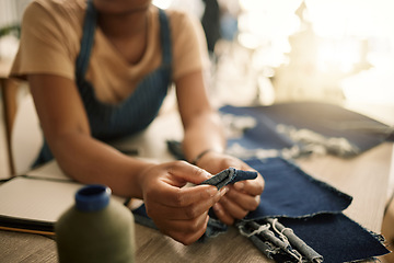 Image showing Fashion design student sewing, learning and making creative denim clothes in a clothing manufacturing factory. Industry, artistic and fashionable designer busy in a workshop working on stylish jeans