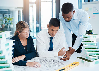 Image showing Designers and architects working on construction plan, planning with blueprint paperwork and talking in a meeting in office at work. Creative colleagues and employees building a house with a design