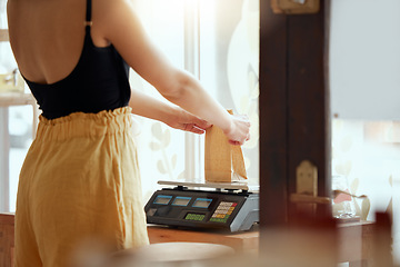 Image showing Employee, entrepreneur or business owner weighing or scaling a product to be sold, bought or delivered. Staff, retail store or grocery worker getting weight of consumables or shopping supplies