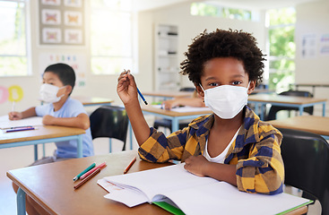 Image showing Child or student in class during covid, wearing a mask for hygiene and protection from coronavirus flu. Portrait kindergarten, preschool or elementary school boy sitting in a classroom ready to learn