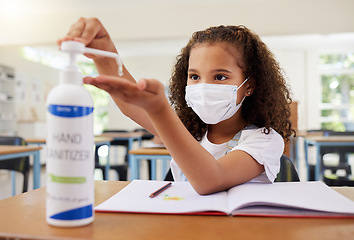 Image showing Sanitizer, covid and clean young girl at elementary school wearing a mask in a classroom. A child following protective covid19 regulations by cleaning her hands to prevent infection