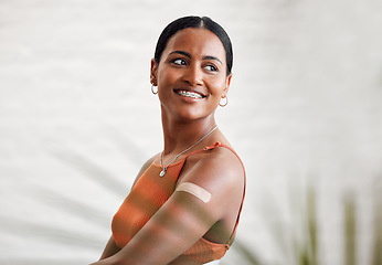 Image showing Covid vaccine, safety and health with plaster after vaccination for business protocol or policy and protection against the virus. Smiling female worker showing her arm after injection