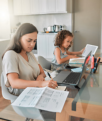 Image showing Mother and daughter being productive with remote work and homework, multitasking at a kitchen table at home. Parent and child serious while paying bills and watching an online education programme