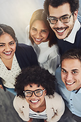 Image showing Diverse group of creative colleagues from above looking excited, happy or motivated and ready to take startup business to the top. Portrait of smiling, happy and cheerful office team standing united