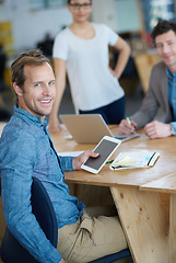 Image showing Smiling marketing manager browsing the internet on a digital tablet in an office. Handsome and happy professional researching creative ideas to promote and advertise a startup on social media